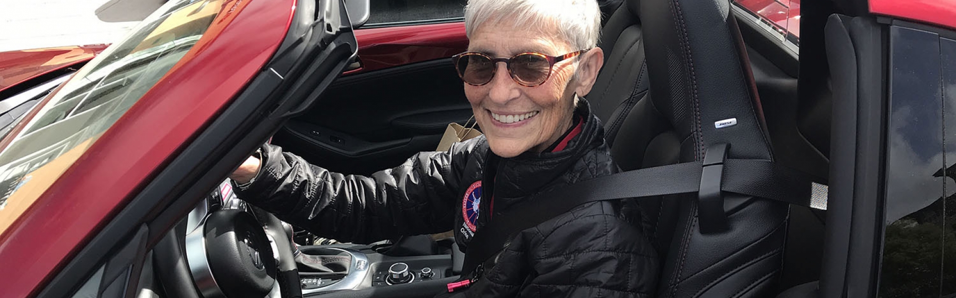 Ann Hallum behind steering wheel of car