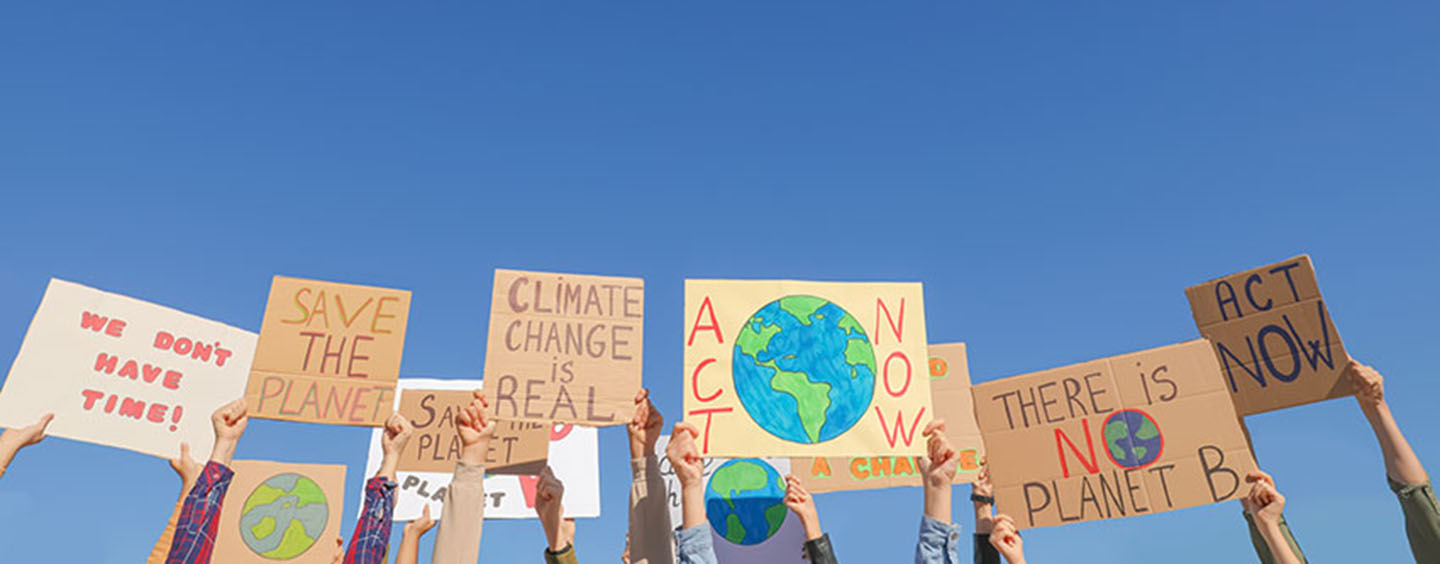 hands holding up climate change signs