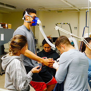 kinesiology students conduct experiment with treadmill and mask