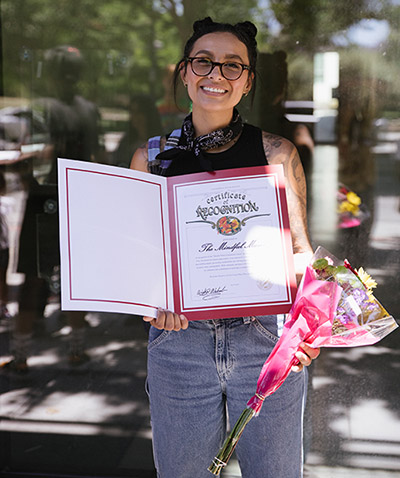 Sofia Dangerfield holding certificate of appreciation