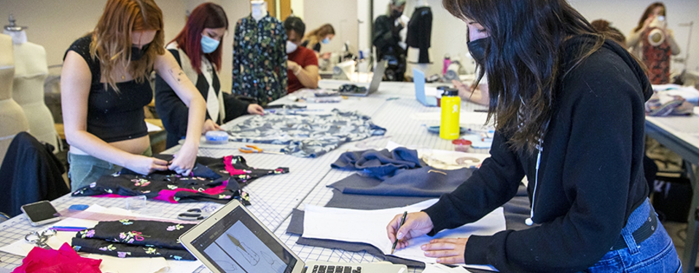students work on garment designs for Goodwill project