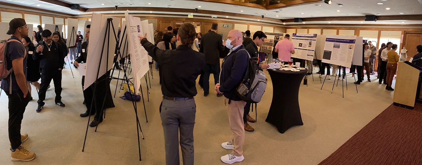 Attendees look at posters at CHSS Undergrad Showcase