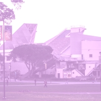 The Cesar Chavez building on campus with a purple filter over it.
