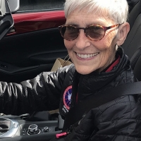 Ann Hallum behind steering wheel of car